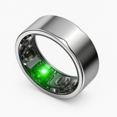 Silver titanium ENSOUL AI smart ring with smooth beveled edges and glowing green sensor
